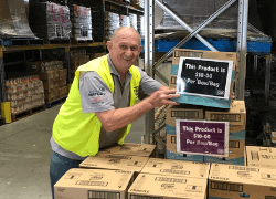 Foodbank Staff Nick showing the foodbank boxes ready for distribution